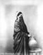Click to see details of a veiled woman with a water...